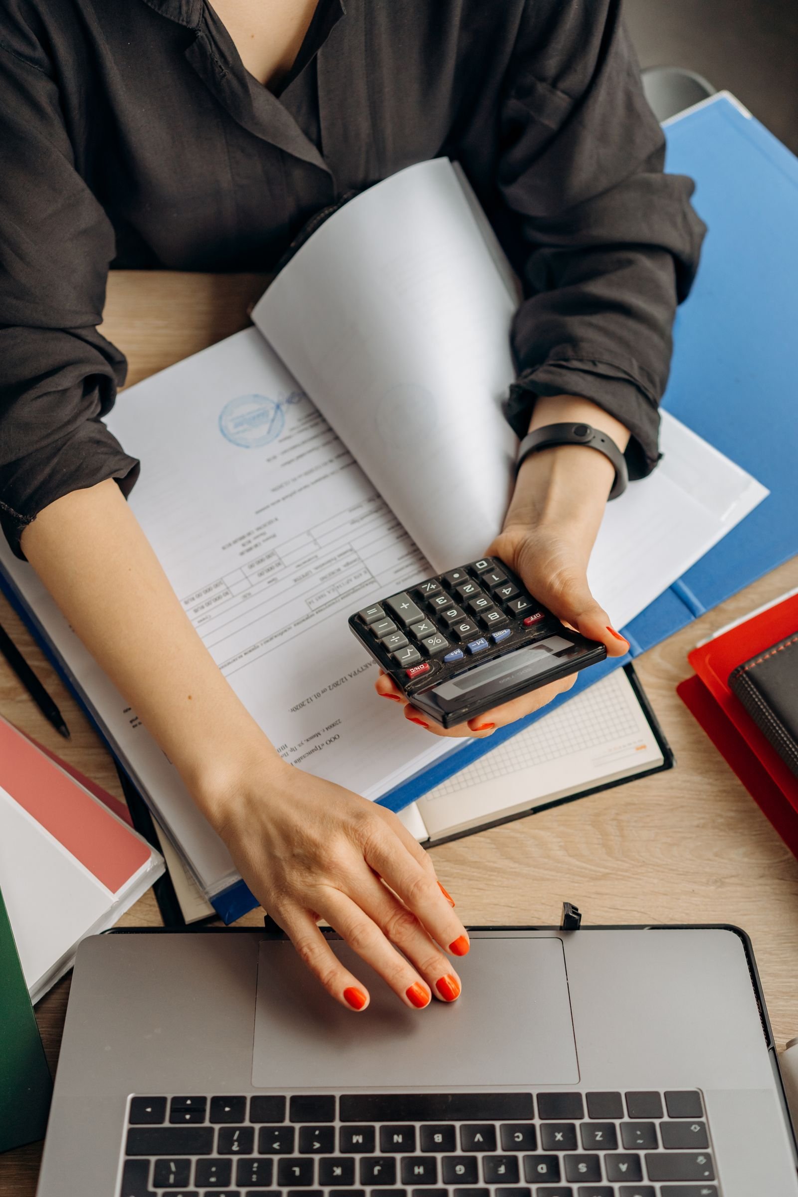 Xero inventory purchase orders — accountant using a calculator with purchase documents for inventory tracking