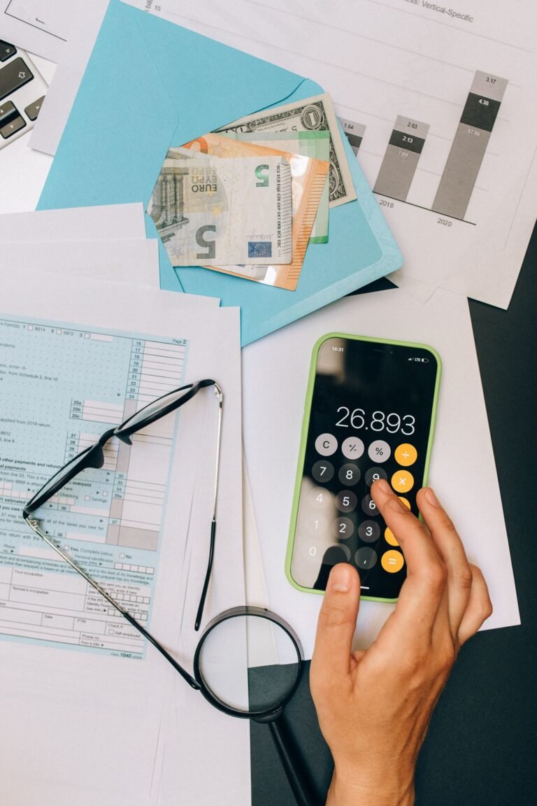 Accounting desk with calculator, financial documents, and glasses for Xero pros and cons review